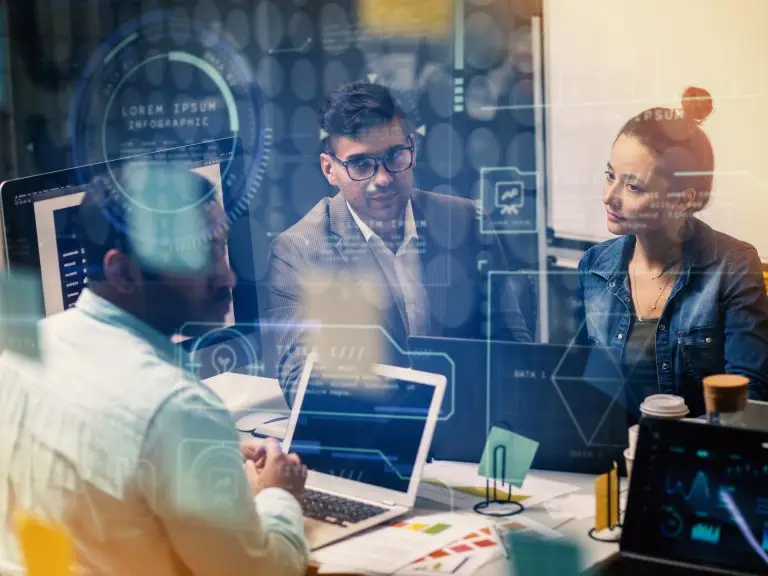 evaluating a business, three people sit around a table