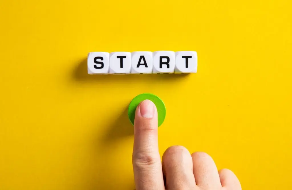 Finger pressing green start button